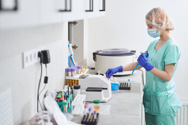 Medical practitioner in laboratory setting, working with medical equipment and samples
