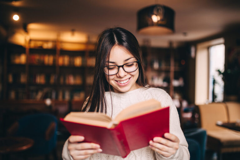 Young woman reading a book, lifestyle and personal interests.