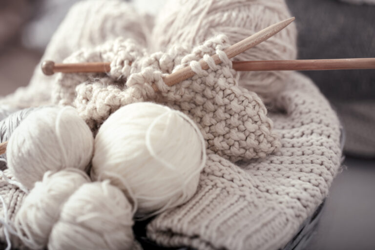 Knitting wool and needles illustrating thermal regulation properties of wool.