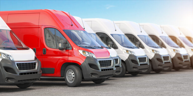 Red delivery van among a row of white vans illustrating fleet management tips.