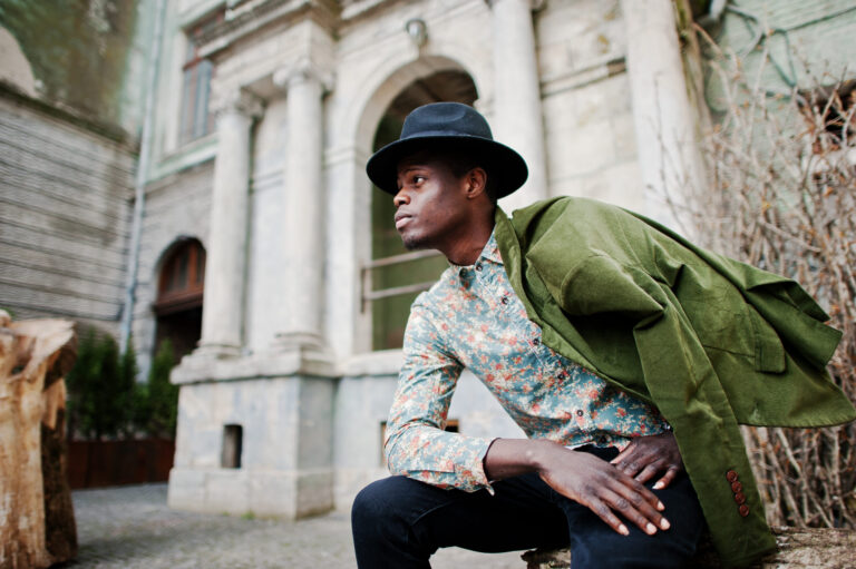 Stylish Black man in hat and jacket, fashion portrait for men's lifestyle.