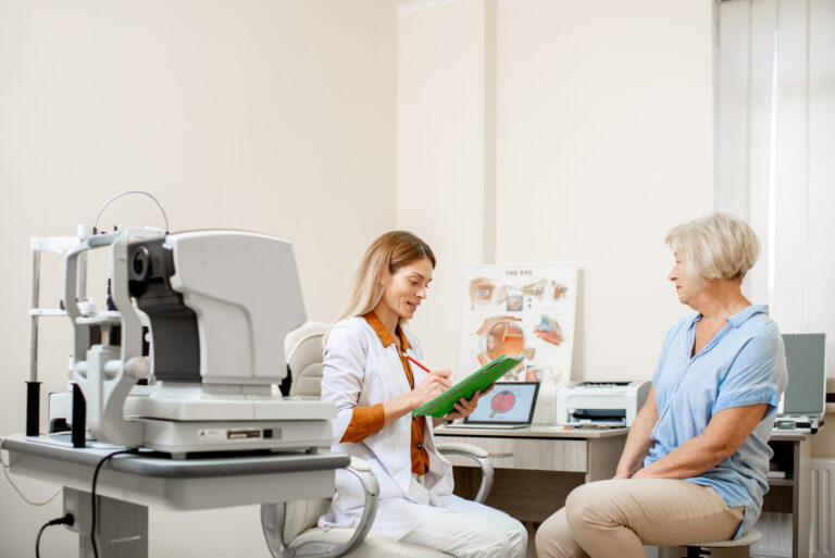 Senior patient and ophthalmologist in office examining eye health