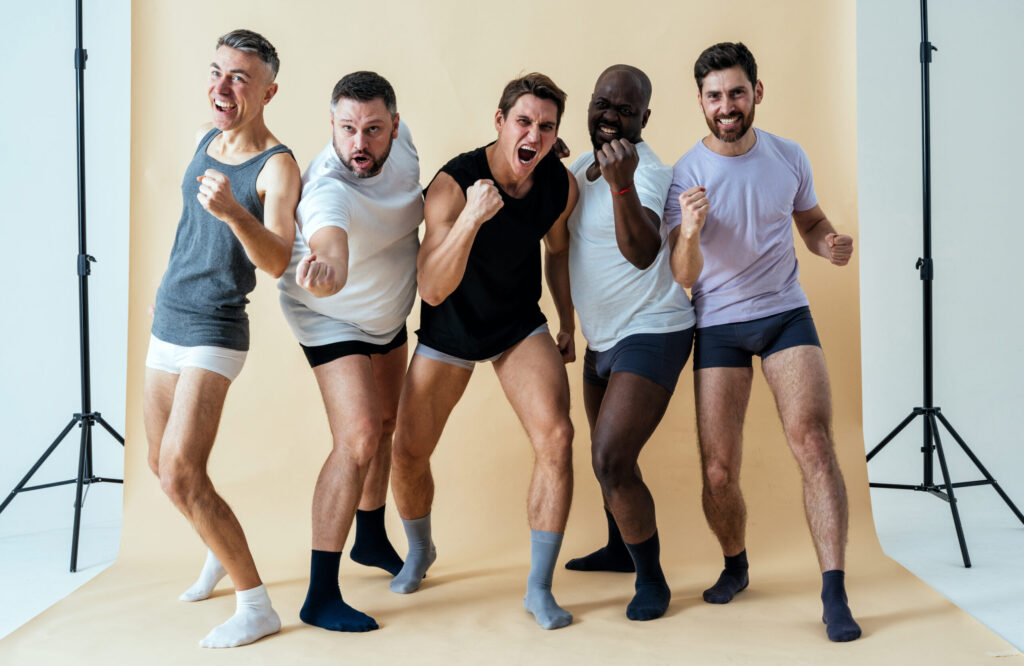 Group of multiethnic men showcasing various men's underwear styles and boxer briefs
